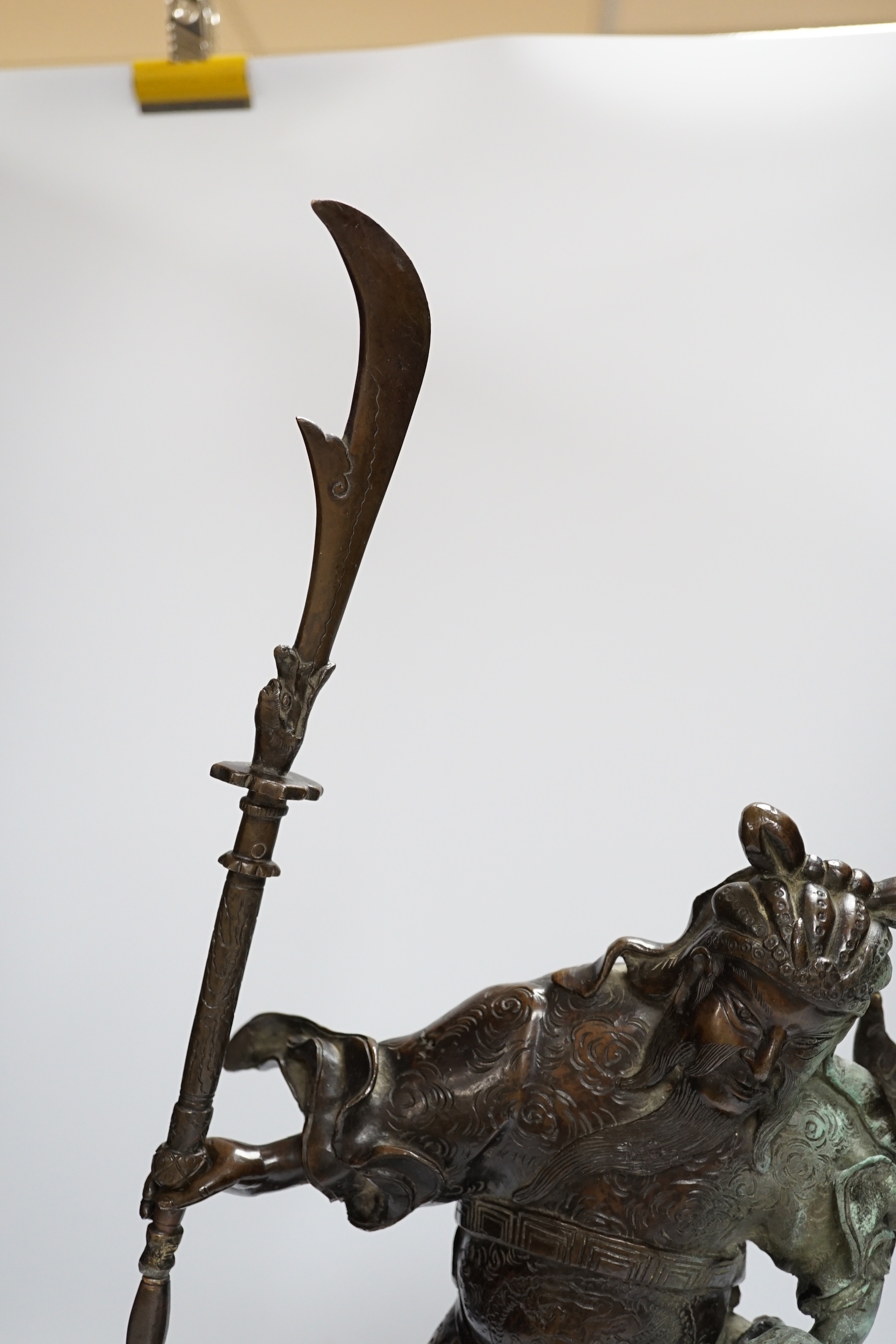 A 19th century Japanese bronze figure of a warrior, raised on naturalist bronze base, 40cm high